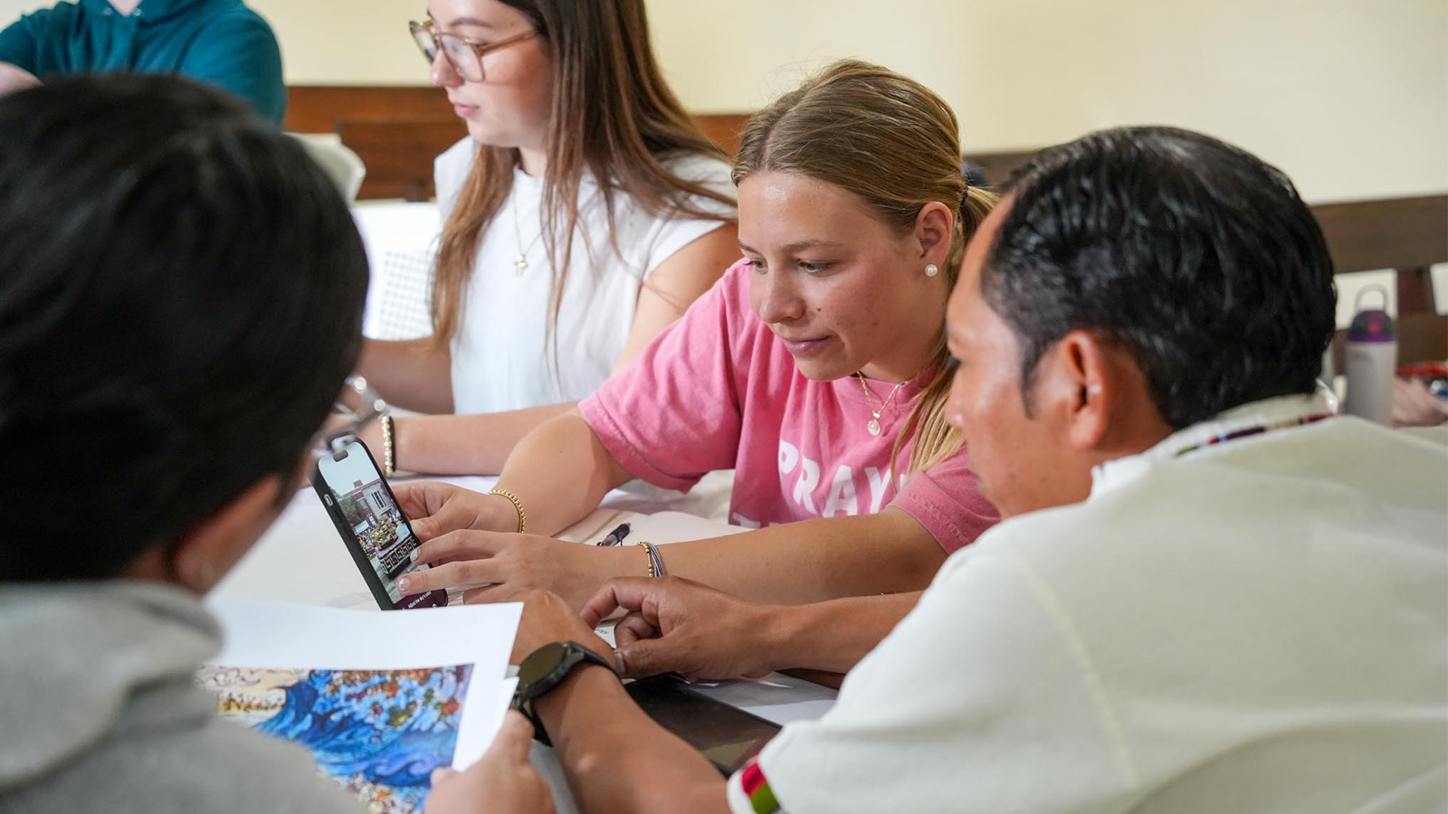 Baylor Interior Design students shows design plans to a partner at Iglesia Bautista Luz de Vida in Bárcena, Guatemala.