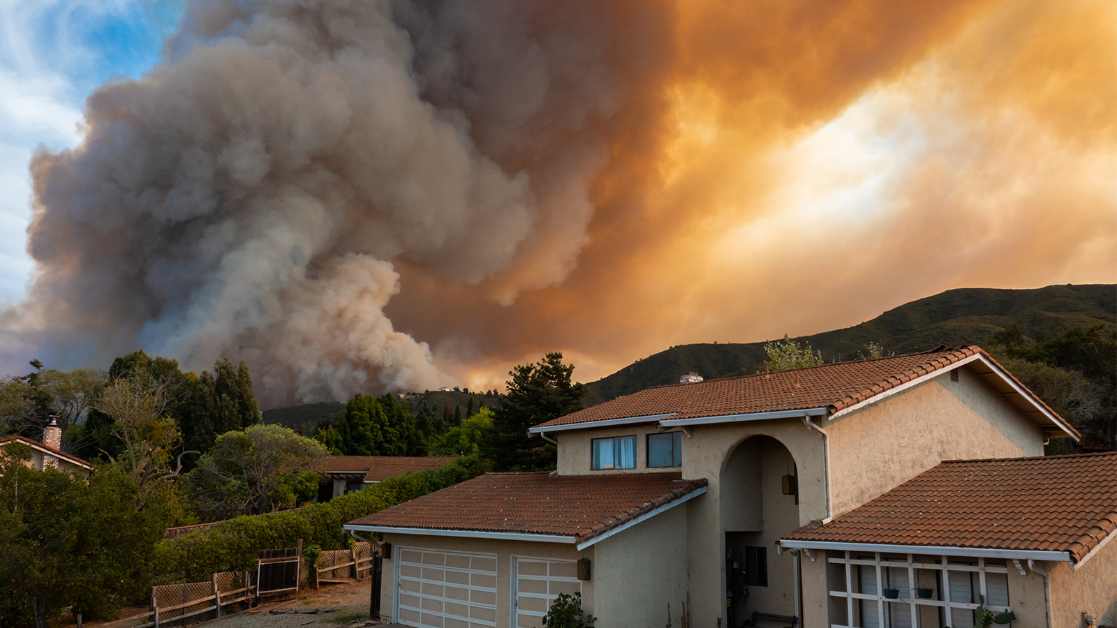 Wildfire and smoke near homes. 