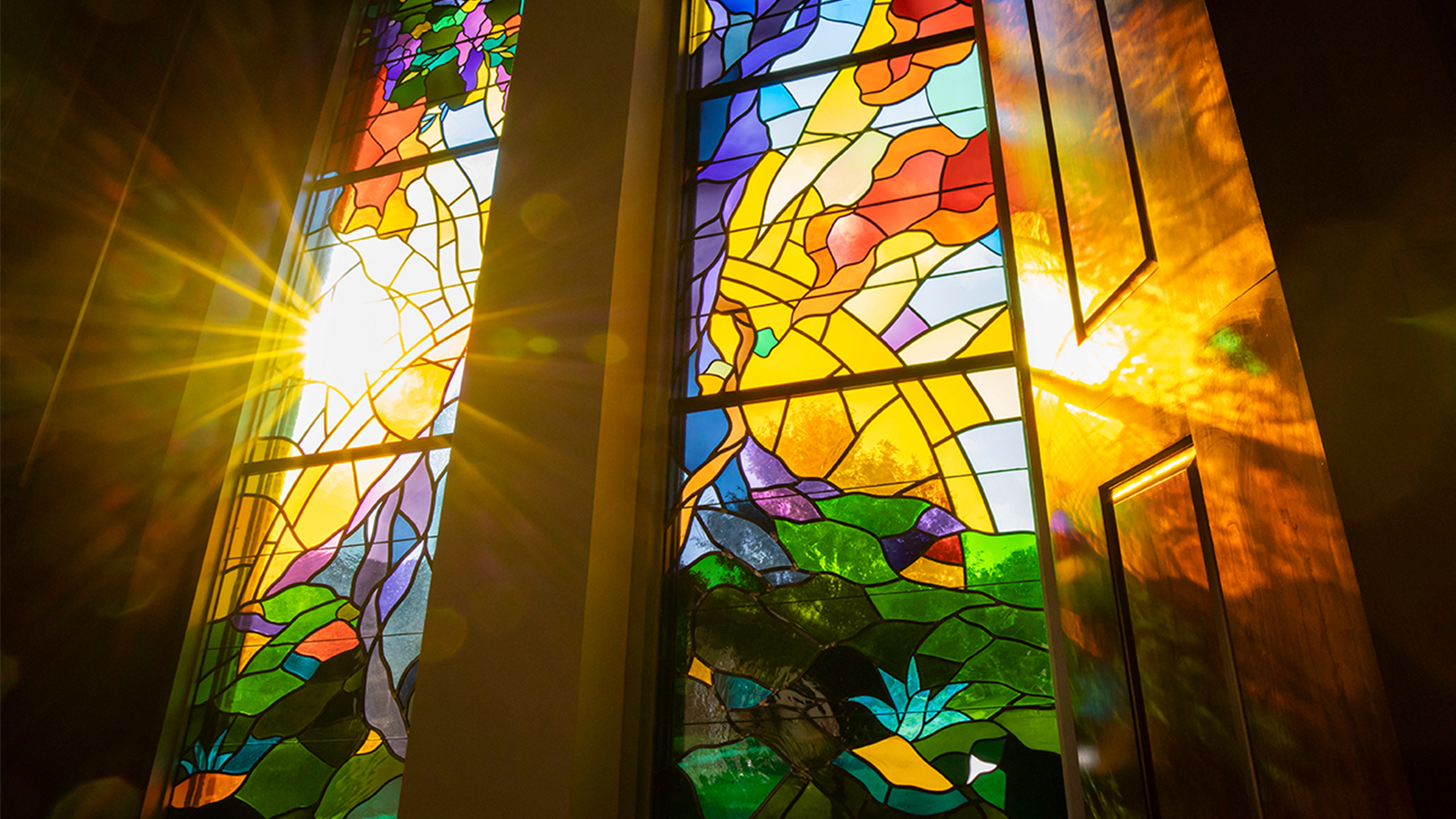 Light shines through stained glass windows 