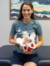 Lindsey Sutton holds a pelvic floor model. 