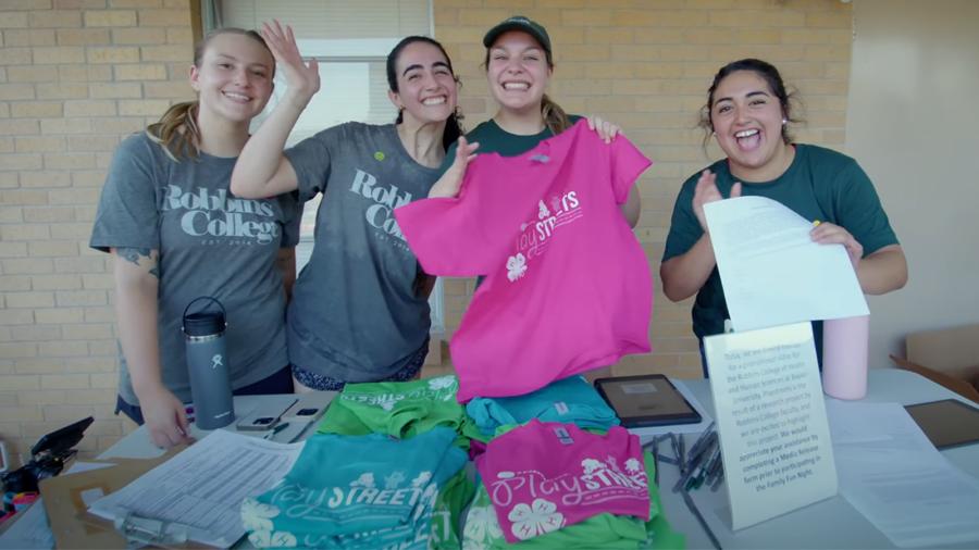 Baylor University Public Health students pass out T-shirts during a Play Street intervention. 