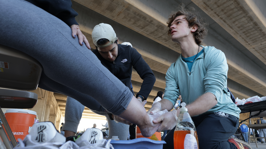 Baylor Public Health students washes the feet of an unsheltered neighbor.