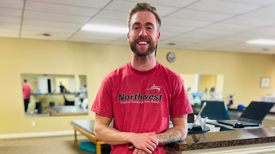 Ethan Torrance in a physical therapy clinic.