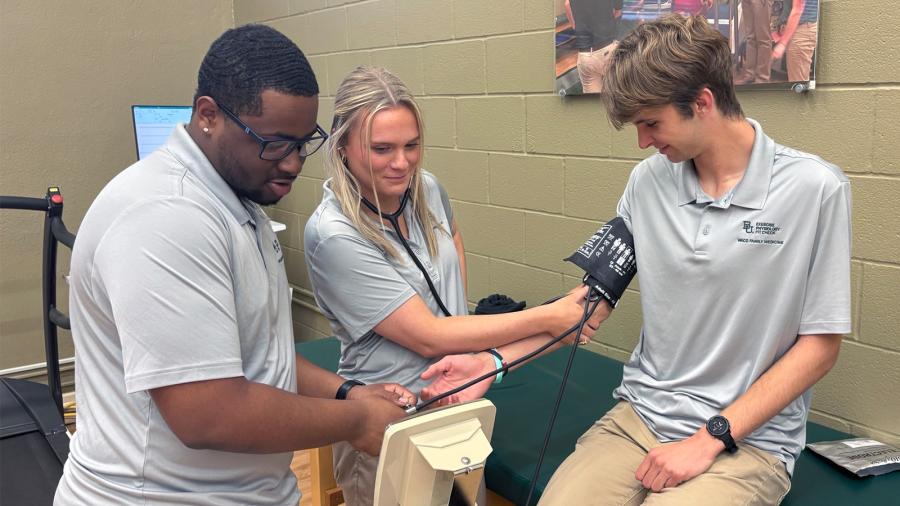 Exercise Physiology students check blood pressure at a comprehensive health and wellness assessment.