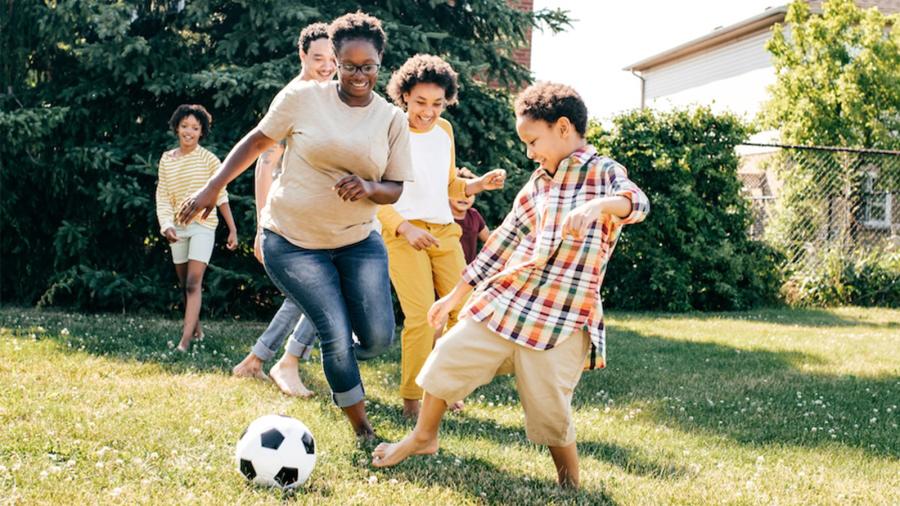 Family playing soccer
