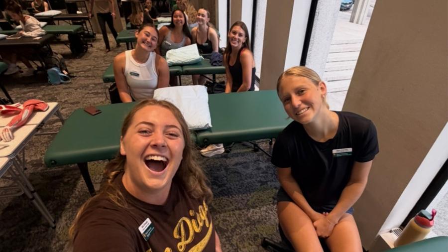 Abbi Schnabel and Keira Shipman with new Doctor of Physical Therapy peers.
