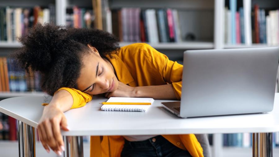 Student sleeps in front of computer